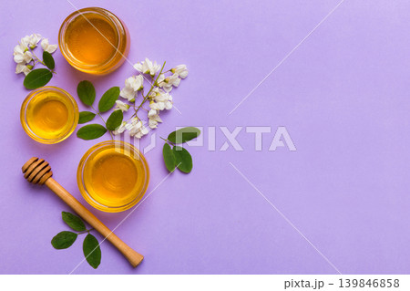 honey jar with acacia flowers and leaves. fresh honey top view flat lay honey jar with acacia flowers and leaves. fresh honey top view flat lay 139846858