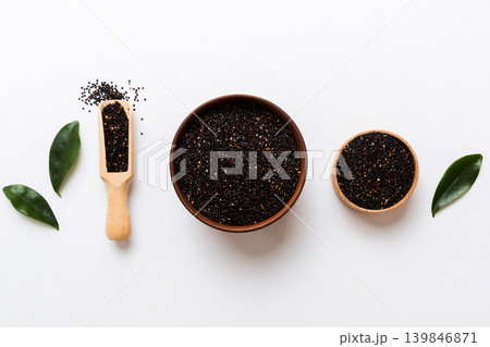 quinoa seeds in bowl and spoon on colored background. Healthy kinwa in small bowl. Healthy superfood quinoa seeds in bowl and spoon on colored background. Healthy kinwa in small bowl. Healthy superfood 139846871