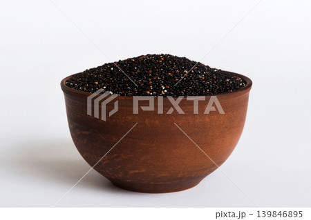 quinoa seeds in bowl on colored background. Healthy kinwa in small bowl. Healthy superfood quinoa seeds in bowl on colored background. Healthy kinwa in small bowl. Healthy superfood 139846895