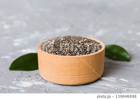 Chia seeds in bowl on colored background. Healthy Salvia hispanica in small bowl. Healthy superfood Chia seeds in bowl on colored background. Healthy Salvia hispanica in small bowl. Healthy superfood 139846898