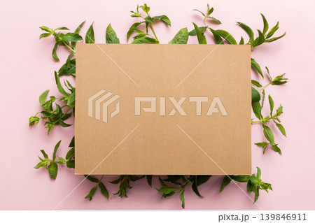 Wreath frame made of empty paper blank with space for text and mint leaves on colored background. . Mint Pattern. Flat lay. Top view Wreath frame made of empty paper blank with space for text and mint leaves on colored background. . Mint Pattern. Flat lay. Top view 139846911