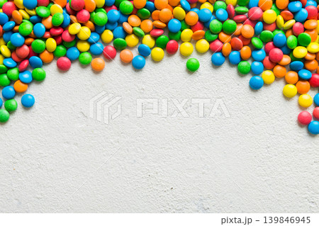 Mixed collection of colorful candy, on colored background. Flat lay, top view. frame of colorful chocolate coated candy 139846945
