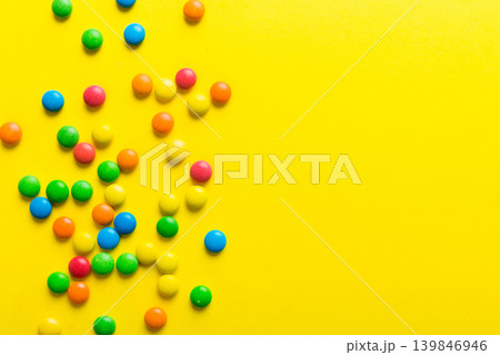 Mixed collection of colorful candy, on colored background. Flat lay, top view. frame of colorful chocolate coated candy Mixed collection of colorful candy, on colored background. Flat lay, top view. frame of colorful chocolate coated candy 139846946