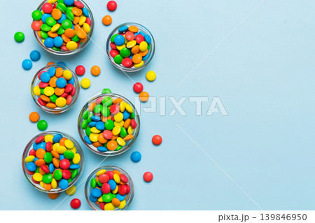 different colored round candy in bowl and jars. Top view of large variety sweets and candies with copy space 139846950