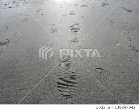 Human footprints on beach sand Human footprints on beach sand 139847042