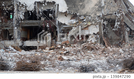Demolished building with construction debris and scrap metal showcasing professional demolition contractor work for urban development and reconstruction projects in commercial real estate industry. 139847290