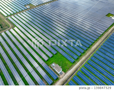Aerial view of solar farm. Sustainable renewable energy and modern photovoltaic technology for eco-friendly electricity production. Solar power station. Green energy solutions. Solar panel technology. Aerial view of solar farm. Sustainable renewable energy and modern photovoltaic technology for eco-friendly electricity production. Solar power station. Green energy solutions. Solar panel technology. 139847329