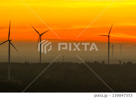 Wind farm field and sunset sky. Wind power. Sustainable, renewable energy. Wind turbines generate electricity. Sustainable development. Green technology for energy sustainability. Eco-friendly energy. 139847353