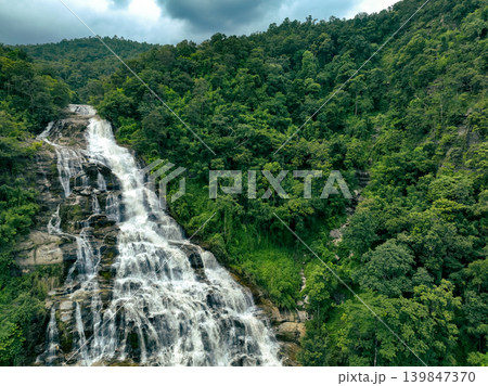 Aerial view of a waterfall in a lush tropical green forest in Doi Inthanon National Park, Chiang Mai, Thailand. This nature landscape showcases water sustainability and scenic travel destinations. 139847370