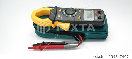 Digital clamp meter tool with probe cables for measuring electrical current and voltage in professional maintenance work on white background for accuracy and safety inspection. Precision testing. Digital clamp meter tool with probe cables for measuring electrical current and voltage in professional maintenance work on white background for accuracy and safety inspection. Precision testing. 139847407