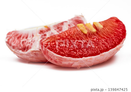 Red pomelo pulp with seeds from Thailand Siam ruby on white background. Fresh tropical fruit rich in vitamin C antioxidant and potassium for healthy diet and anti aging concept. Wellness nutrition. Red pomelo pulp with seeds from Thailand Siam ruby on white background. Fresh tropical fruit rich in vitamin C antioxidant and potassium for healthy diet and anti aging concept. Wellness nutrition. 139847425