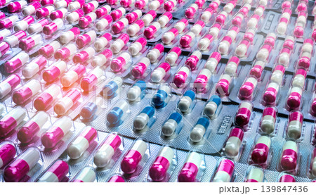 Antibiotic capsules in blister packs in large quantity for pharmaceutical supply. Antimicrobial resistance risk and responsible drug use in global healthcare system. Pharmaceutical production storage. 139847436