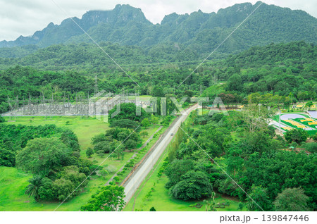 Landscape of a hydroelectric dam power station surrounded by lush green mountains and dense forest, representing renewable energy infrastructure and sustainable electricity generation in nature. Landscape of a hydroelectric dam power station surrounded by lush green mountains and dense forest, representing renewable energy infrastructure and sustainable electricity generation in nature. 139847446