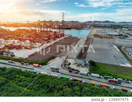 Logistics and transportation of container cargo ship at ship port. Container truck and crane bridge in shipyard. Import export and transport industry. Terminal port for export transport by ship. Logistics and transportation of container cargo ship at ship port. Container truck and crane bridge in shipyard. Import export and transport industry. Terminal port for export transport by ship. 139847475