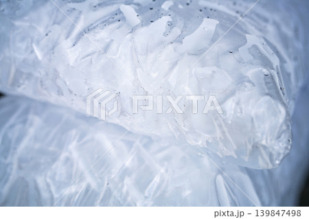 Closeup of tube ice inside a clear plastic bag. Convenient and lightweight packaging designed for easy transportation and storage. Hygiene and freshness for commercial and industrial applications. 139847498