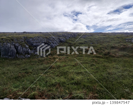 Cloudy Sky Over Natural Landscape with Bedrock and Grassland Terrain 139847547