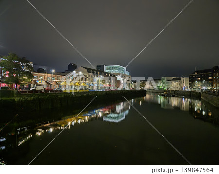 Night City Buildings Reflections In City River With Colorful Lights And Bridges, Cork City In Ireland At Night Night City Buildings Reflections In City River With Colorful Lights And Bridges, Cork City In Ireland At Night 139847564