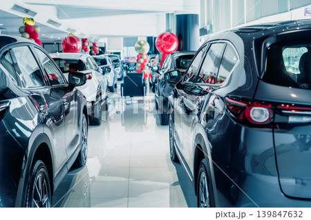 Selective focus grey car parked in luxury showroom. Car dealership office. New car parked in modern showroom. Car for sale and rent business concept. Automobile leasing and insurance background. 139847632