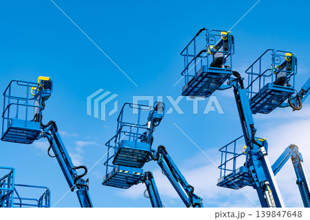 Articulated boom lift. Aerial platform lift. Telescopic boom lift against blue sky. Mobile construction crane for rent and sale. Maintenance and repair hydraulic boom lift service. Crane dealership. Articulated boom lift. Aerial platform lift. Telescopic boom lift against blue sky. Mobile construction crane for rent and sale. Maintenance and repair hydraulic boom lift service. Crane dealership. 139847648
