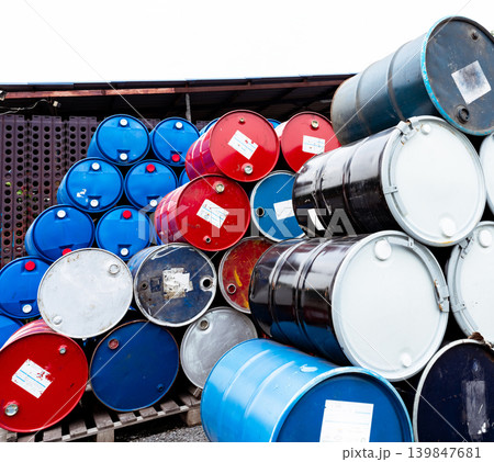 Stack of old chemical barrels. Blue, black and red oil drum. Steel and plastic oil tank. Toxic waste warehouse. Hazard chemical barrel. Industrial waste in drum. Hazard waste storage in factory. Stack of old chemical barrels. Blue, black and red oil drum. Steel and plastic oil tank. Toxic waste warehouse. Hazard chemical barrel. Industrial waste in drum. Hazard waste storage in factory. 139847681