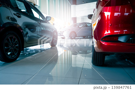 A stylish electric car parked inside a luxury dealership office where customers browse and rent automobiles in a modern showroom showcasing clean energy technology and urban transportation innovation. A stylish electric car parked inside a luxury dealership office where customers browse and rent automobiles in a modern showroom showcasing clean energy technology and urban transportation innovation. 139847761