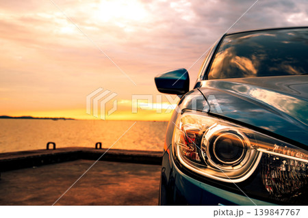 Luxury car detail at sunset by the sea, eco friendly vehicle care and sustainable transport concept. Clean energy technology, modern automotive service and environmental awareness. Hybrid electric car Luxury car detail at sunset by the sea, eco friendly vehicle care and sustainable transport concept. Clean energy technology, modern automotive service and environmental awareness. Hybrid electric car 139847767