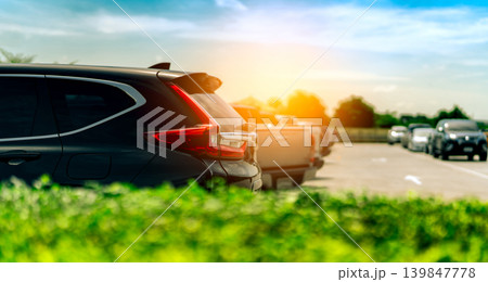 SUV Car parked on concrete parking area at factory near the sea with blue sky and clouds. Car dealership. Car stock for sale. Car factory parking lot. Automotive Industry. Used automobile business. 139847778