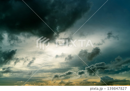 Sunset sky and gray and golden clouds. Gray sky and fluffy clouds. Thunder and storm sky. Sad and moody sky. Dead abstract background. Cloudscape. Peaceful and tranquil background. Beauty in nature. 139847827