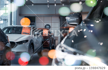Selective focus white car parked in luxury showroom. Car dealership office. New car parked in modern showroom. Car for sale and rent business concept. Automobile leasing and insurance background. Selective focus white car parked in luxury showroom. Car dealership office. New car parked in modern showroom. Car for sale and rent business concept. Automobile leasing and insurance background. 139847829
