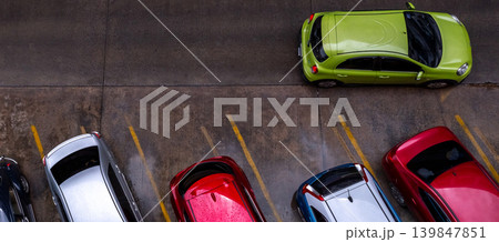 Top view of car parked at concrete car parking lot with yellow line of traffic sign on the street. Above view of car in a row at parking space. No available parking slot. Outside car parking area. Top view of car parked at concrete car parking lot with yellow line of traffic sign on the street. Above view of car in a row at parking space. No available parking slot. Outside car parking area. 139847851