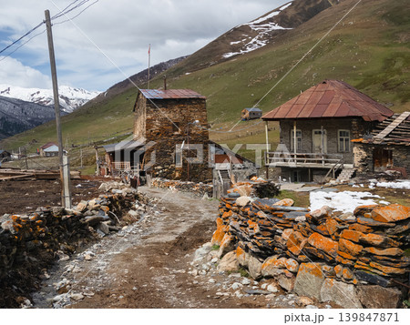 Ushguli, Georgia. Ancient stone homes stand beside a winding path. Ushguli, Georgia. Ancient stone homes stand beside a winding path. 139847871