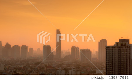 Air pollution in Bangkok, Thailand. Smog and fine dust of pm2.5 covered city in the morning with orange sunrise sky. Cityscape with polluted air. Dirty environment. Urban toxic dust. Unhealthy air. 139847911