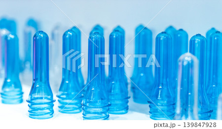 PET plastic bottle preforms before blow molding. Packaging industry. PET preforms from preforms injection molding machine. Raw material for PET bottle. Recycle plastic. Polyethylene terephthalate. PET plastic bottle preforms before blow molding. Packaging industry. PET preforms from preforms injection molding machine. Raw material for PET bottle. Recycle plastic. Polyethylene terephthalate. 139847928