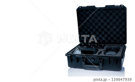Drone kit in hard protective case, aerial device with accessories and LiPo battery for photography, videography and inspection tasks, modern technology equipment for safe transport and organization. 139847939