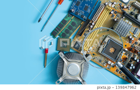 Computer chip and magnifying glass. Chipset on electronic circuit board of PC motherboard at repair workshop. CPU chip. Electronic components. Computer hardware. Upgrade computer processor chip. Computer chip and magnifying glass. Chipset on electronic circuit board of PC motherboard at repair workshop. CPU chip. Electronic components. Computer hardware. Upgrade computer processor chip. 139847962
