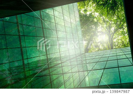 Eco-friendly building in modern city. Sustainable glass office building with trees for reducing CO2. Green architecture. Building with green environment. Sustainability corporate. Net zero emissions. Eco-friendly building in modern city. Sustainable glass office building with trees for reducing CO2. Green architecture. Building with green environment. Sustainability corporate. Net zero emissions. 139847987