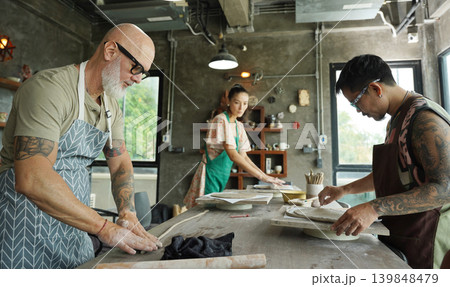 A happy couple makes ceramic plates in a workshop A happy couple makes ceramic plates in a workshop 139848479