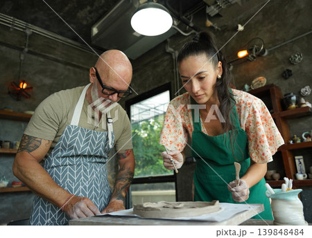 A happy couple makes ceramic plates in a workshop A happy couple makes ceramic plates in a workshop 139848484