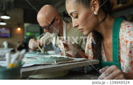 A happy couple makes ceramic plates in a workshop A happy couple makes ceramic plates in a workshop 139848524