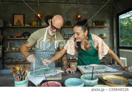 A happy couple makes ceramic plates in a workshop A happy couple makes ceramic plates in a workshop 139848526