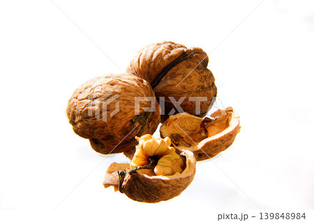 Close-Up Walnuts With Cracked Shells On White Background - Healthy Organic Nut Snack And Ingredient Close-Up Walnuts With Cracked Shells On White Background - Healthy Organic Nut Snack And Ingredient 139848984