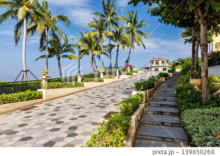 Phu Quoc, Vietnam - January 3 2026: Palm-lined tropical promenade near seaside restaurant in Phu Quoc Phu Quoc, Vietnam - January 3 2026: Palm-lined tropical promenade near seaside restaurant in Phu Quoc 139850268