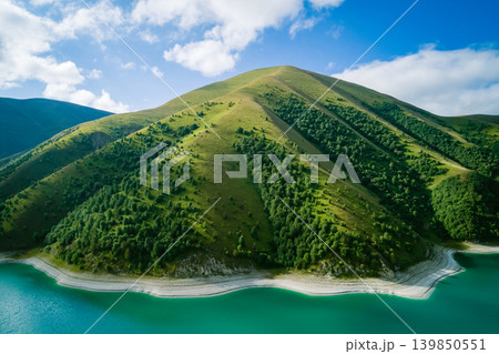 Aerial view captures deep turquoise waters of Kazenoy-Am lake gently curve along a light shoreline Aerial view captures deep turquoise waters of Kazenoy-Am lake gently curve along a light shoreline 139850551