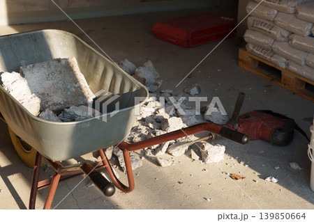 Construction work tools and debris in unfinished interior space Construction work tools and debris in unfinished interior space 139850664