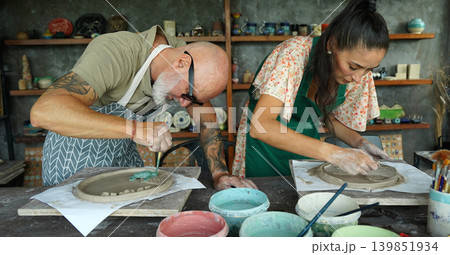 A happy couple makes ceramic plates in a workshop A happy couple makes ceramic plates in a workshop 139851934