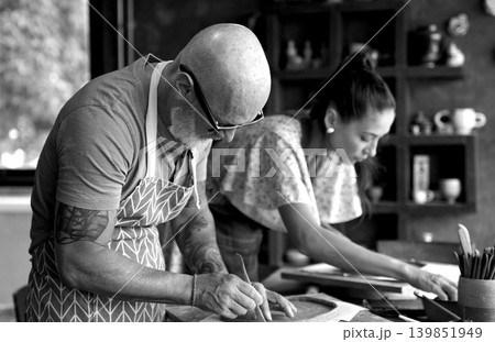 A happy couple makes ceramic plates in a workshop A happy couple makes ceramic plates in a workshop 139851949
