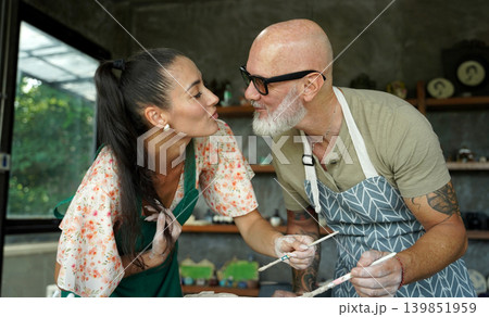 A happy couple makes ceramic plates in a workshop A happy couple makes ceramic plates in a workshop 139851959