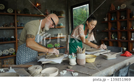 A happy couple makes ceramic plates in a workshop A happy couple makes ceramic plates in a workshop 139851969