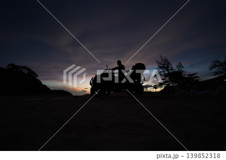 A man engages in extreme ATV riding on mountains in the evening A man engages in extreme ATV riding on mountains in the evening 139852318