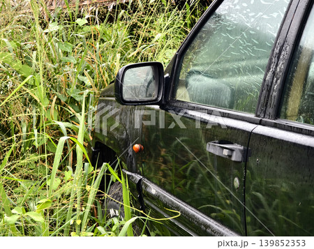 Abandoned jeep lost amidst lush foliage and decay 139852353